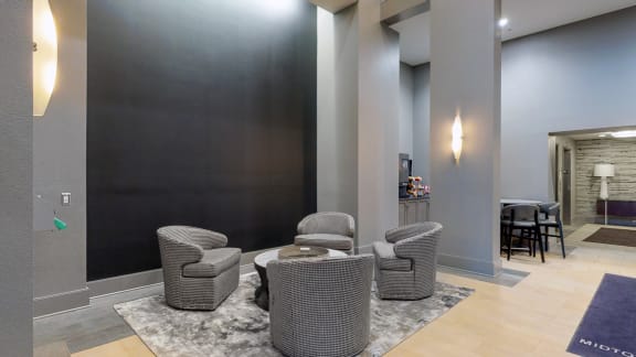 Lobby at Midtown Crossing Apartments in Omaha Nebraska featuring plenty of seating and a coffee station