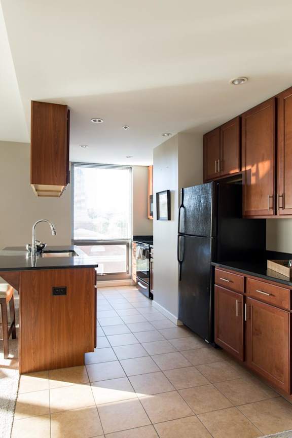 Galley kitchen with black appliances and tons of cabinets