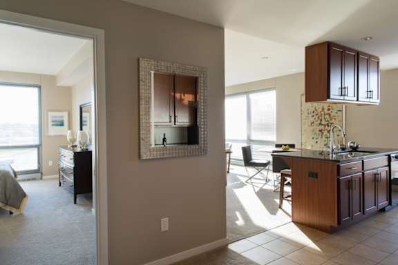 view of door into bedroom and kitchen island and living room