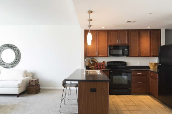 fully equipped eat-in kitchen complete with seating at an attached breakfast bar