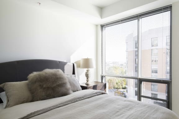 Floor to ceiling windows in the bedrooms of Midtown Crossing apartments provide plenty of natural light in the rooms