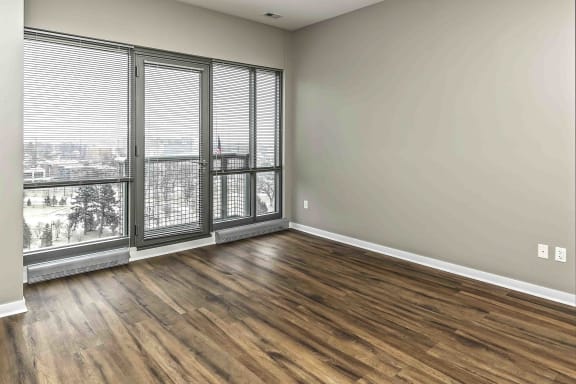 Wood flooring and 10 to 12 foot windows in living room at Midtown Crossing