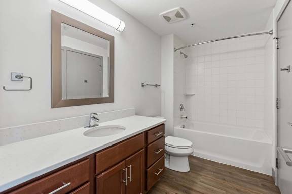 A bathroom with a white sink and a white toilet.
