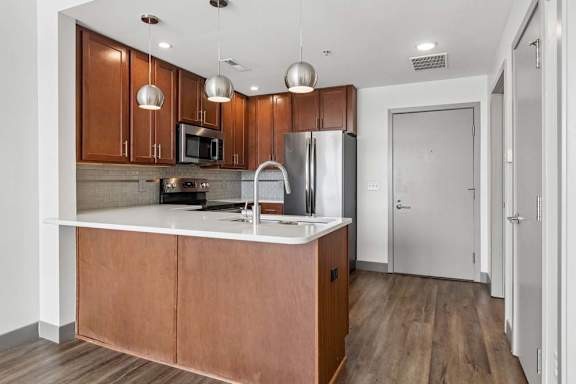 A kitchen with wooden cabinets and a white countertop.