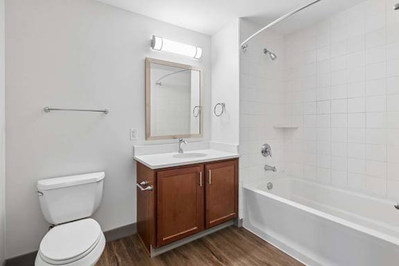 A white toilet sits next to a sink in a bathroom.