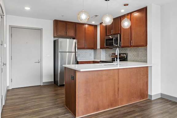 A kitchen with wooden cabinets and a white countertop.