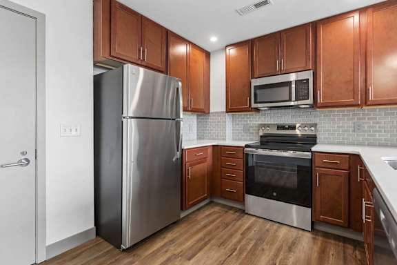 A kitchen with wooden cabinets and stainless steel appliances.