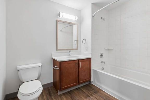 A white toilet sits next to a sink in a bathroom.