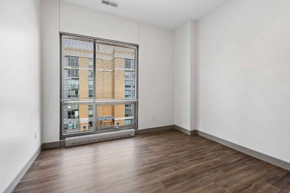 A room with a large window overlooking a building.