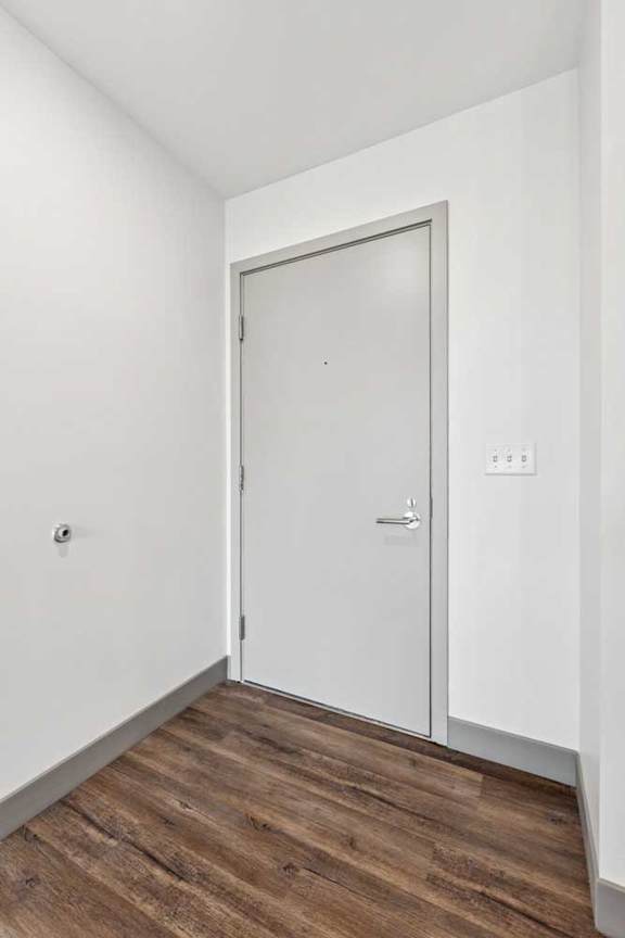 An entryway with a grey front door.