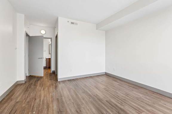 A room with wooden floors and white walls.