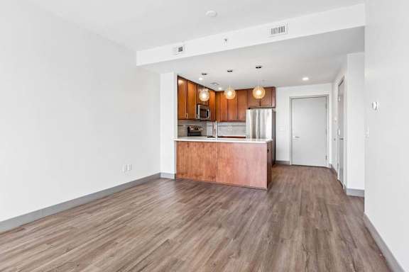 A kitchen with wooden floors and white walls.