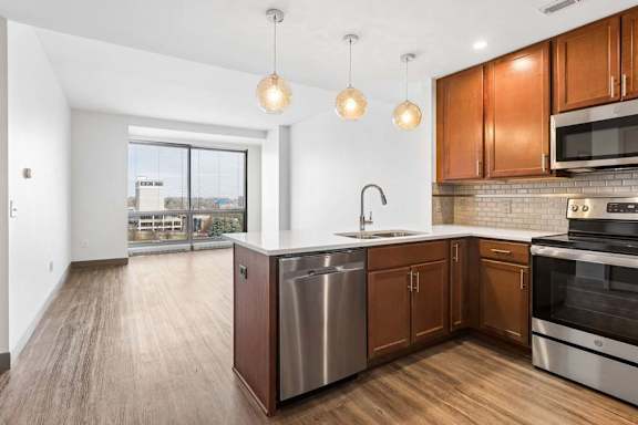A modern kitchen with wooden cabinets and stainless steel appliances.