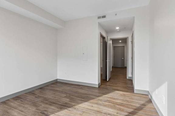 A room with a wooden floor and white walls.