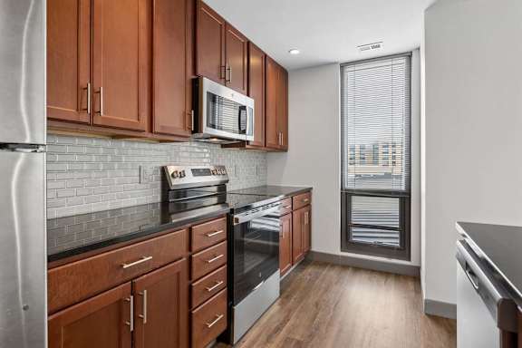 A kitchen with wooden cabinets and stainless steel appliances.