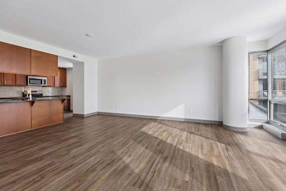 A kitchen with wooden floors and white walls.