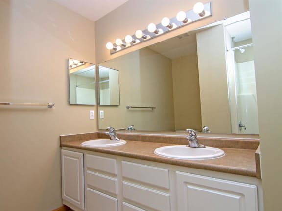 Master Bathroom with dual sinks and white cabinetry at Cascade Pines Duplex Homes in Lincoln NE