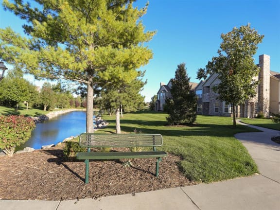 Exteriors-Sitting bench next to private pond at Stone Ridge Estates townhomes in Lincoln, NE