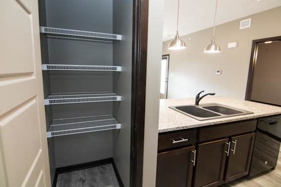 A kitchen with a refrigerator and a sink.