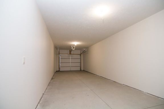 An empty tandem garage with door closed