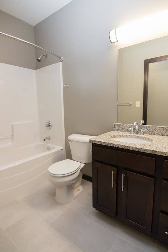 A bathroom with a toilet, sink, and bathtub.