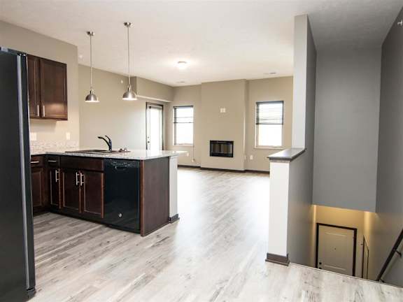 Kitchen and living room with view of stairs to the lower level at North Pointe Villas
