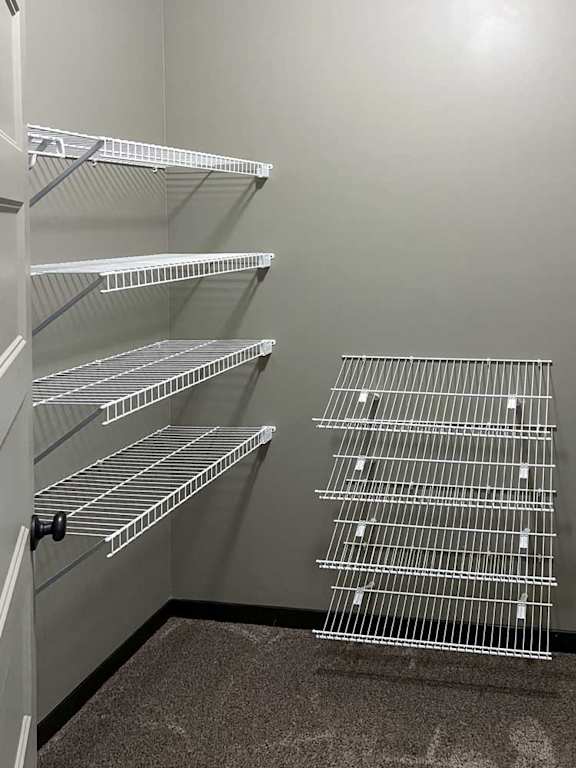 a walk-in closet with built-in shelving and hanging space