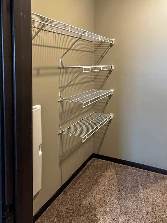 a walk-in closet with built-in shelving and hanging space