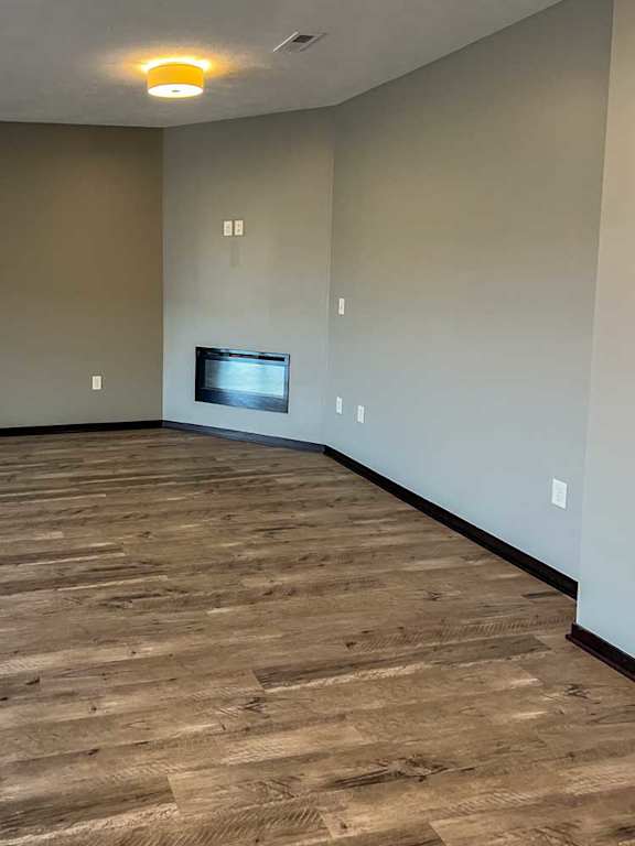 a living room with hardwood flooring and a fireplace