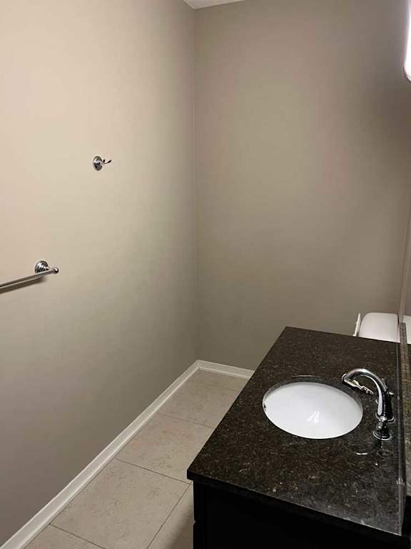 a bathroom with a granite vanity sink