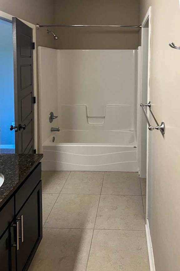 a bathroom with a tub shower