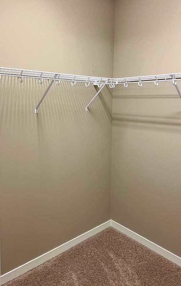 a walk-in closet with built-in shelving and hanging space