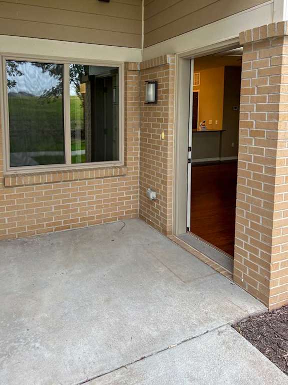 the front door patio space with a large window to the bedroom