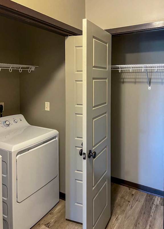 a laundry room next to hall closet