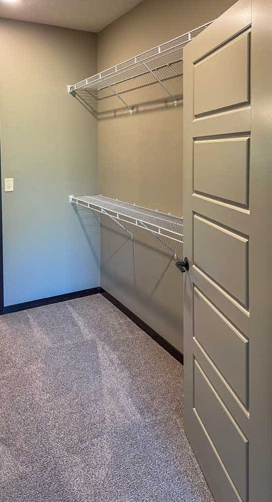 a walk-in closet with built in shelving and hanging space
