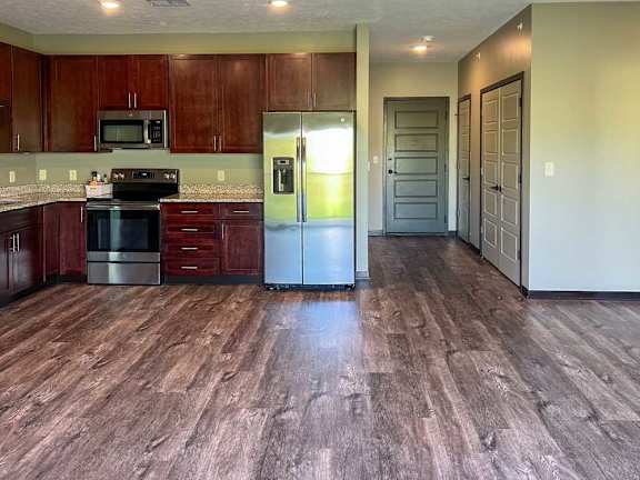a kitchen with wooden cabinets and stainless steel appliances