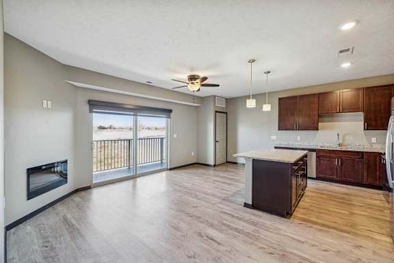 A spacious living room with a fireplace and sliding glass doors.