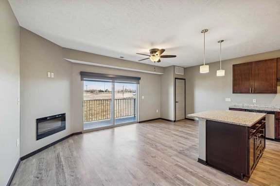 A spacious living room with a fireplace and sliding glass doors.