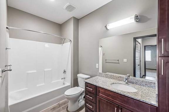 A bathroom with a white toilet and a white shower.