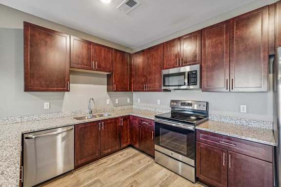 A kitchen with wooden cabinets and stainless steel appliances.