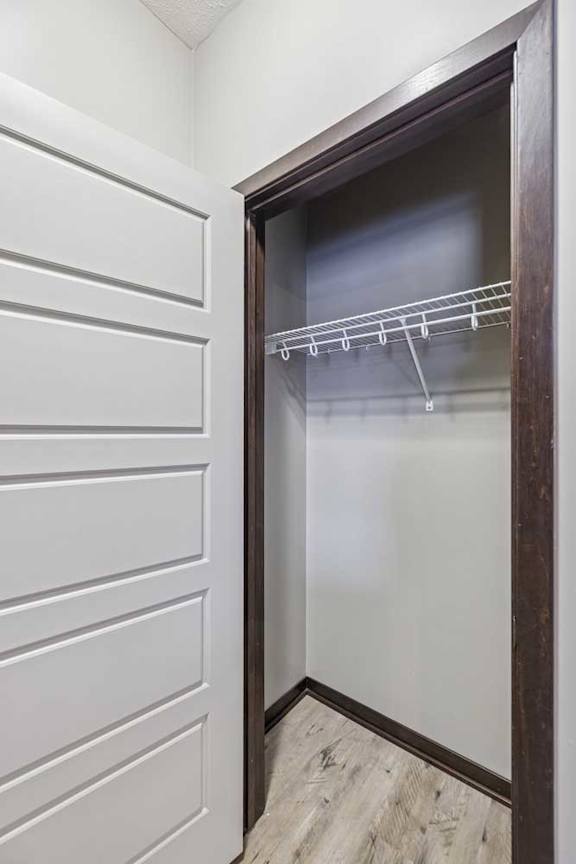 A white closet with a glass door and a shelf.