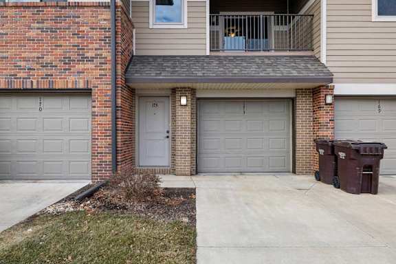 A two-story residential building with a balcony on the second floor.