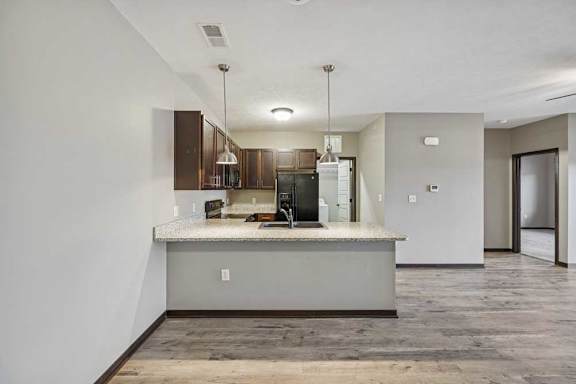 A kitchen with a countertop and a refrigerator.