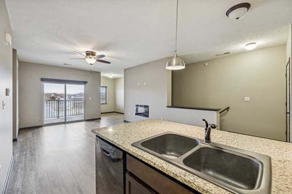A kitchen with a sink and a fan.