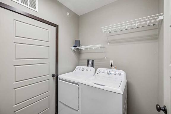 A white washer and dryer in a small laundry room.
