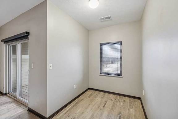 A room with a window and a sliding glass door.