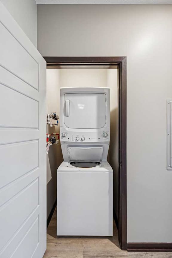 A white washing machine and dryer in a small laundry room.