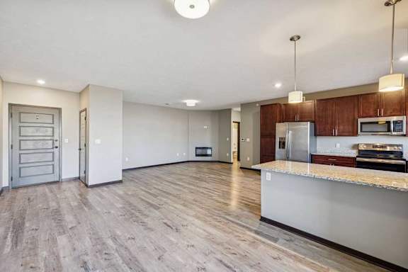 A kitchen with wooden floors and a countertop.