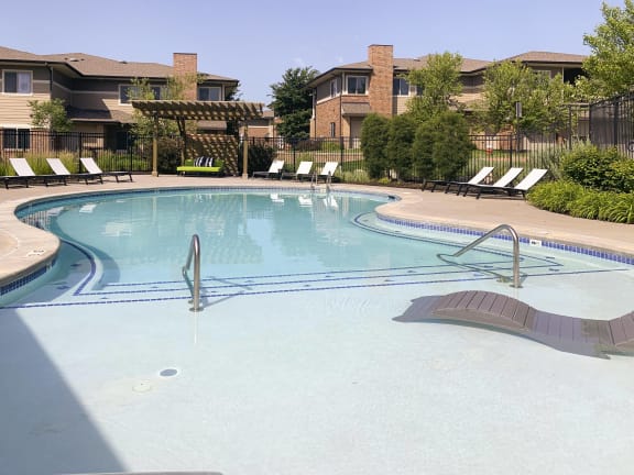Resort style swimming pool with sun tanning loungers at North Pointe  Villas Lincoln Nebraska