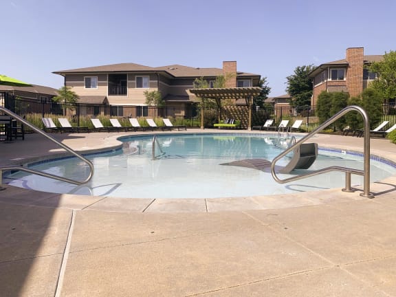 Resort style swimming pool with sun tanning loungers at North Pointe  Villas Lincoln Nebraska